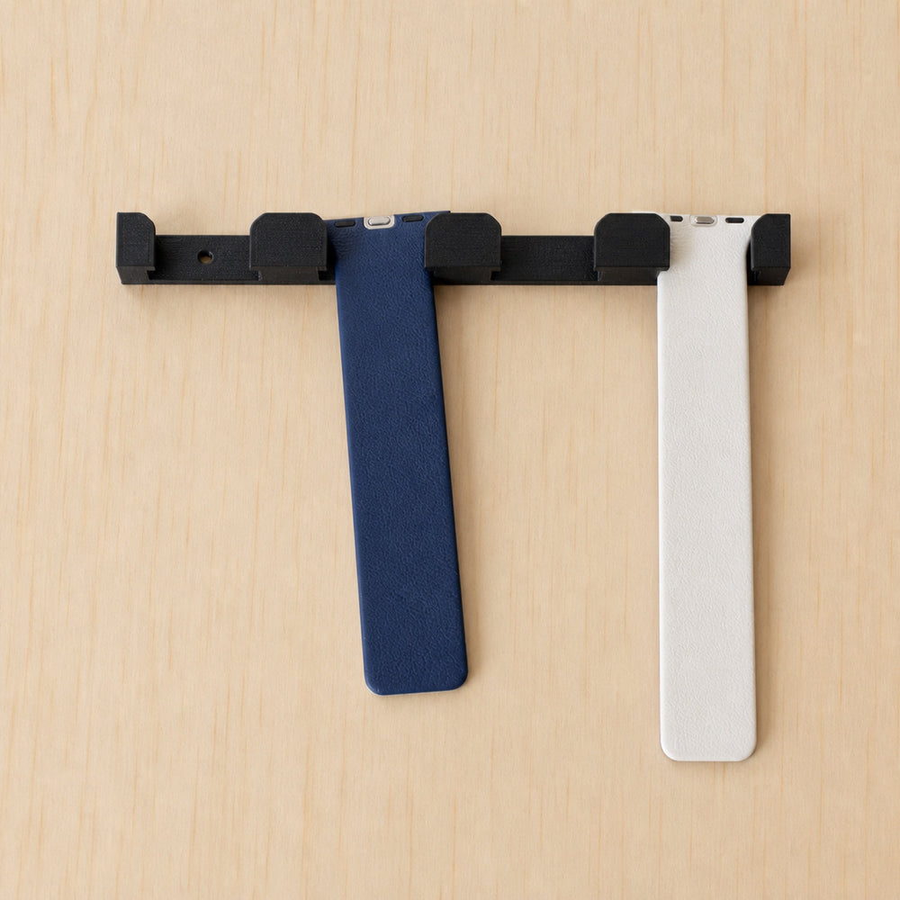 Black four-band Apple Watch wall holder with blue and white bands fitted