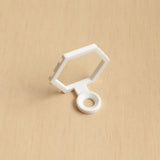 White modular golf ball display mount on pale wood