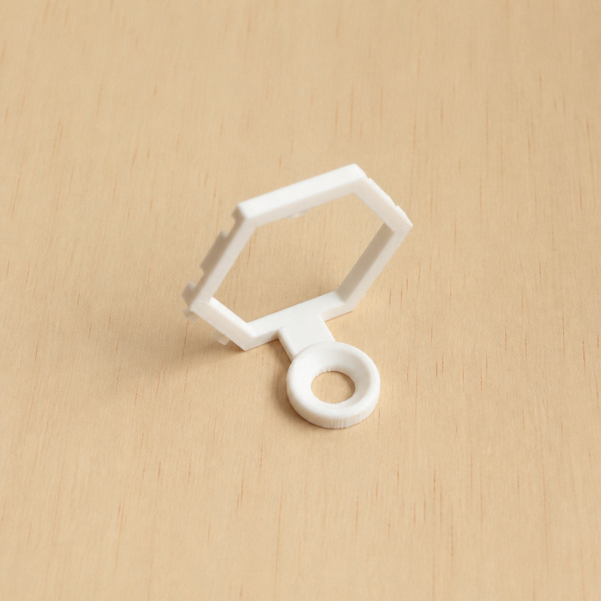 White modular golf ball display mount on pale wood