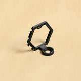 Black modular golf ball display mount on pale wood