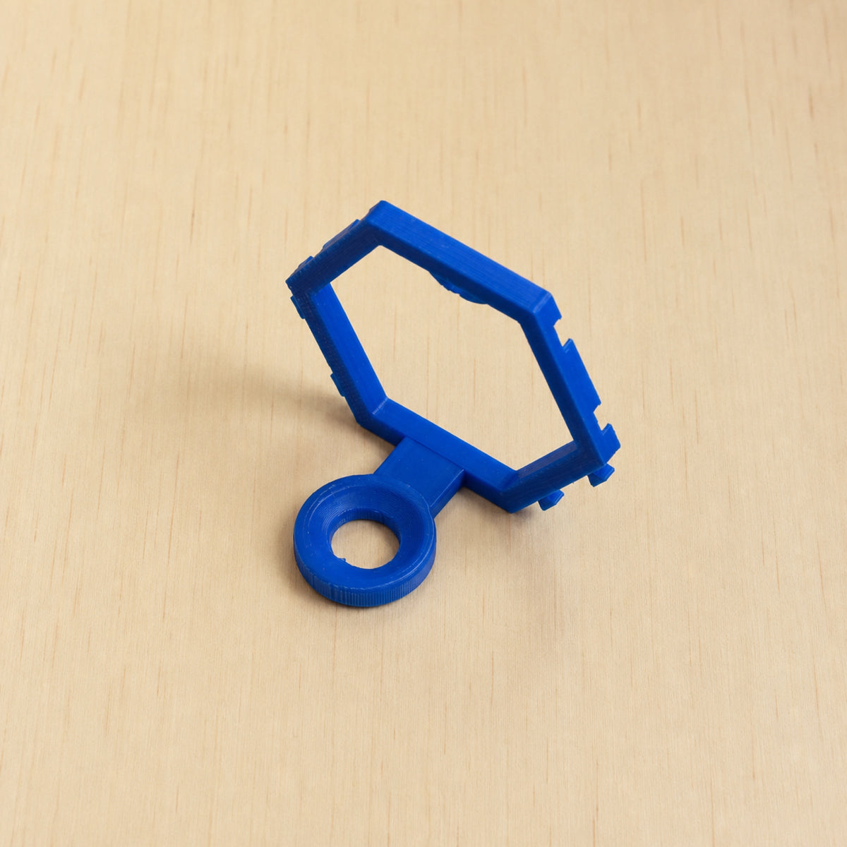 Blue modular golf ball display mount on pale wood