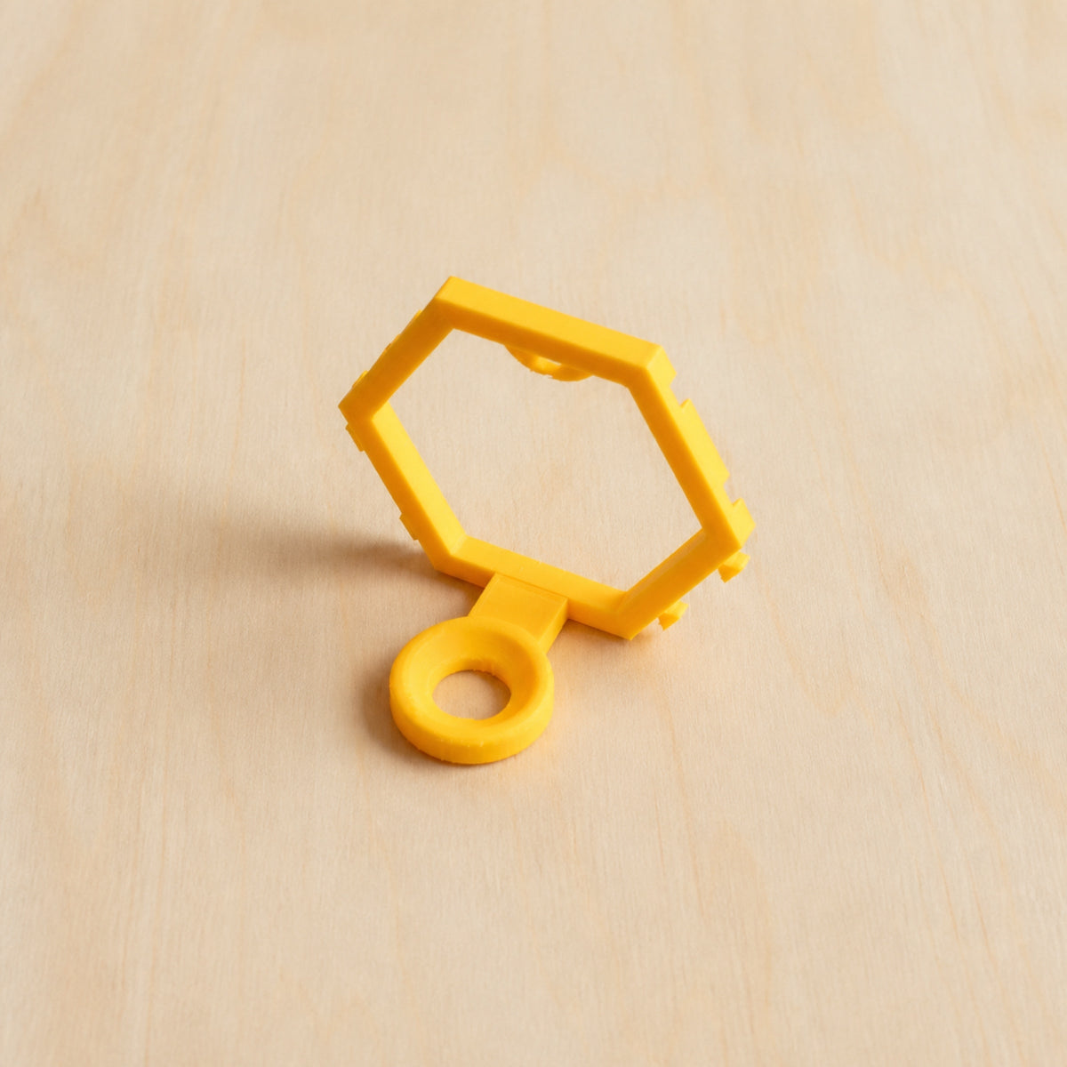 Yellow modular golf ball display mount on pale wood