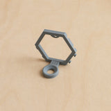 Grey modular golf ball display mount on pale wood