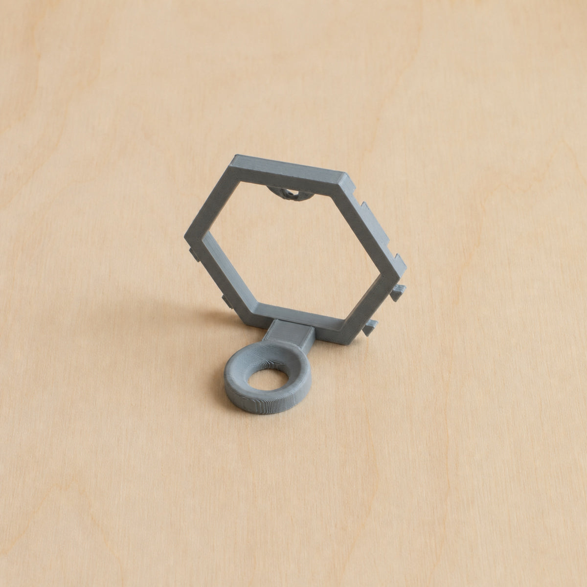 Grey modular golf ball display mount on pale wood