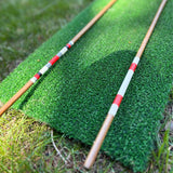 Close up of red and white hand painted bands on the hickory alignment sticks