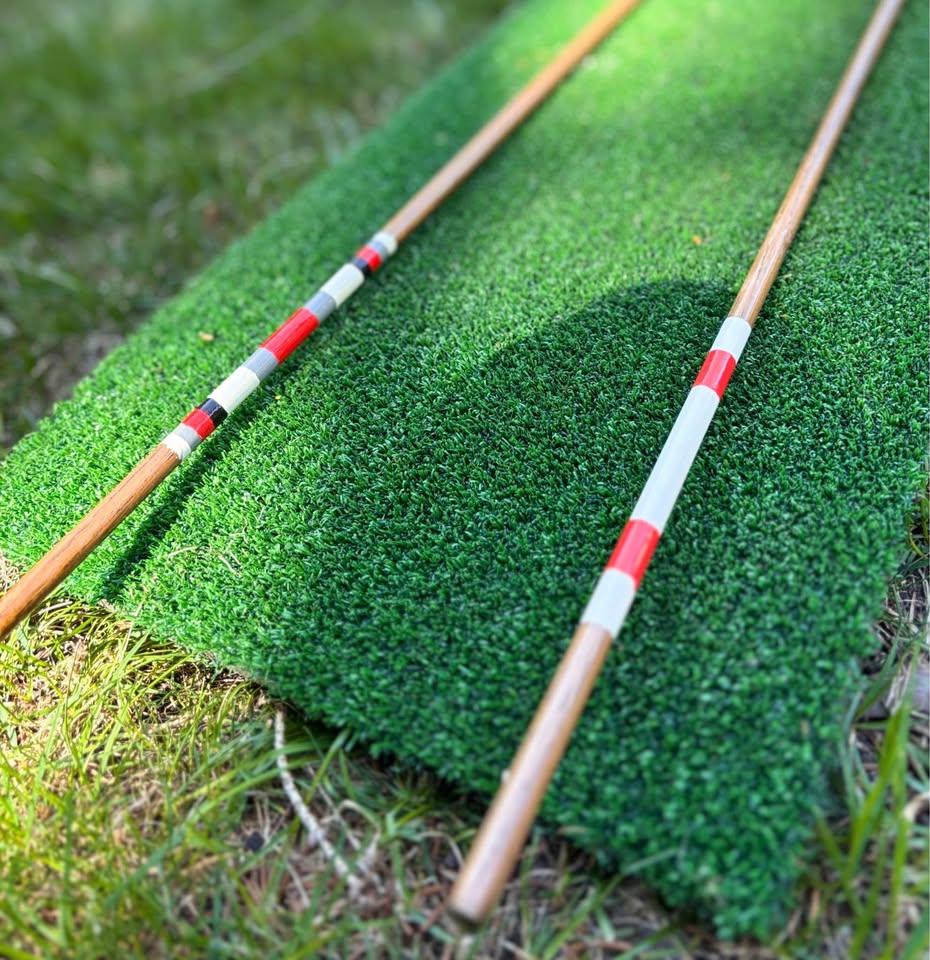 Close up of red and white hand painted bands on the hickory alignment sticks