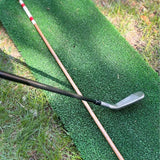 Hickory alignment stick shown next to a golf iron for scale