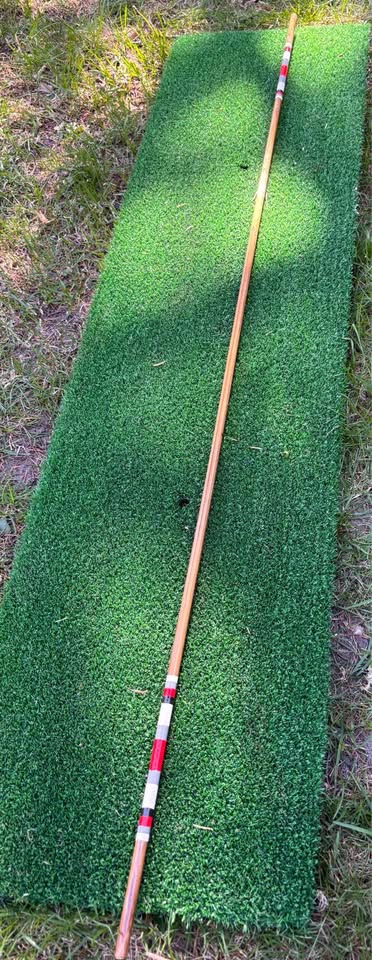 Full length 48 inch hickory golf alignment stick on a mat