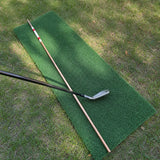 Hickory golf alignment stick beside a golf iron for scale