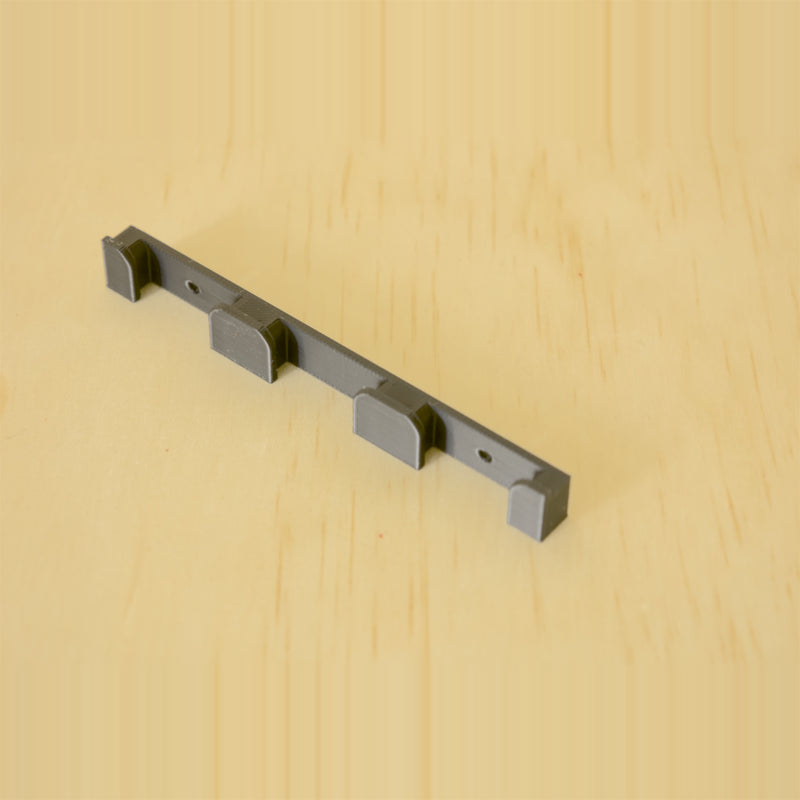 Black three-band Apple Watch band wall holder shown at an angle
