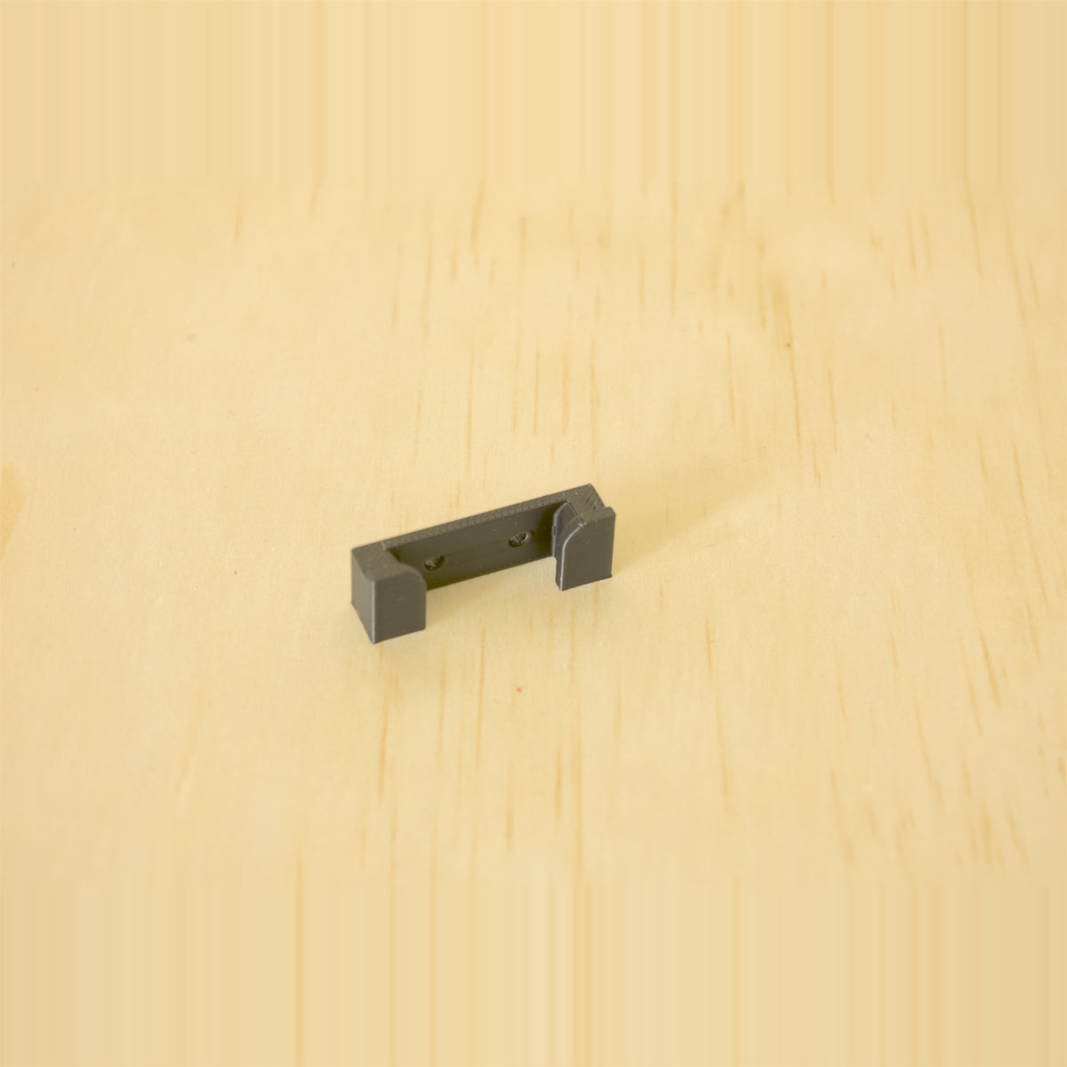 Compact black one-band Apple Watch band wall holder