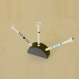 Angled view of a black curved golf tee display holding three tees