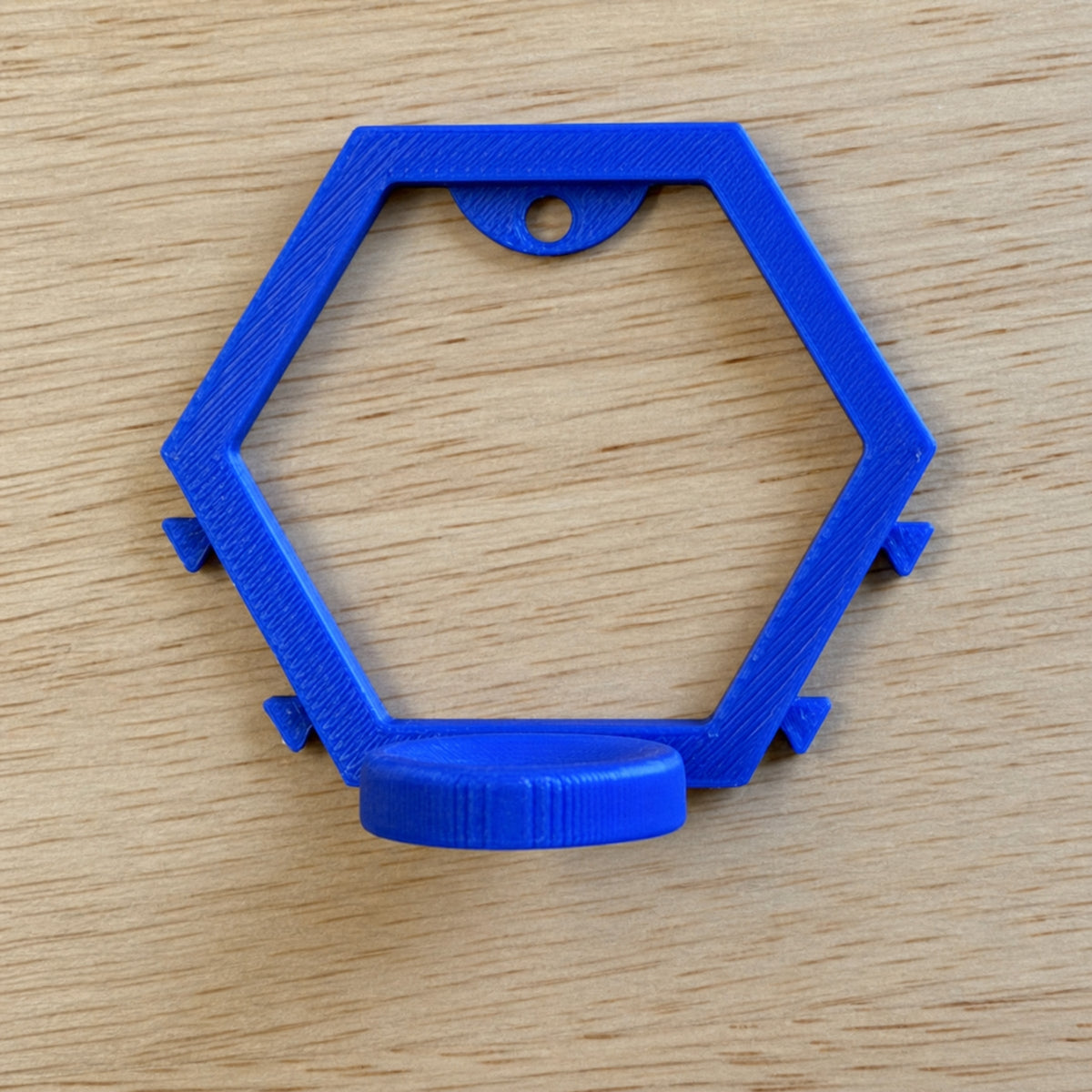 Blue modular golf ball display mount shown from the front