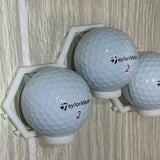 Three golf balls in the modular wall mount, side view