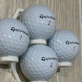 Golf balls and an empty mount connected on the wall