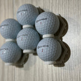 Cluster of golf balls in connected wall mounts
