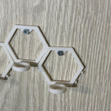 Empty modular golf ball wall mount showing the hexagonal frame