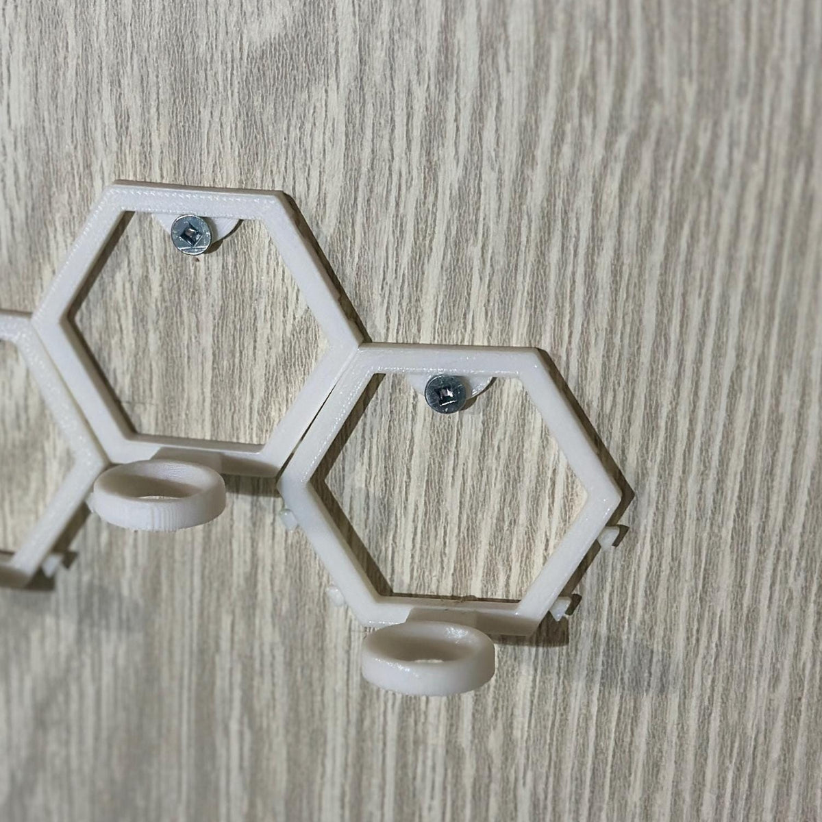 Empty modular golf ball wall mount showing the hexagonal frame