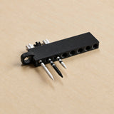 Black golf tee holder loaded with tees, angled product view