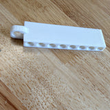 White 3D printed golf tee holder with eight tee slots