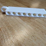 Golf tee holder showing the eight tee openings
