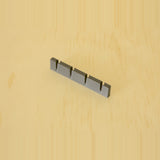 Empty black wall-mounted golf tee display showing four tee positions