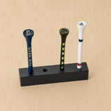 Detailed angled view of a black freestanding four-position golf tee display