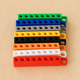 Eight Golf Tee Holders showing eight colour examples on pale wood