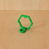 Green modular golf ball display mount on pale wood