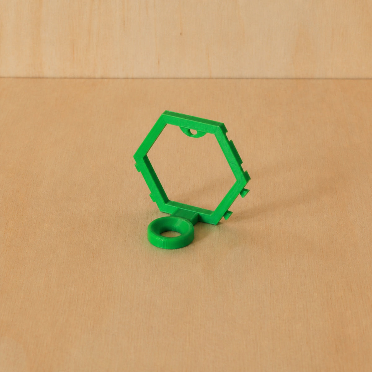 Green modular golf ball display mount on pale wood