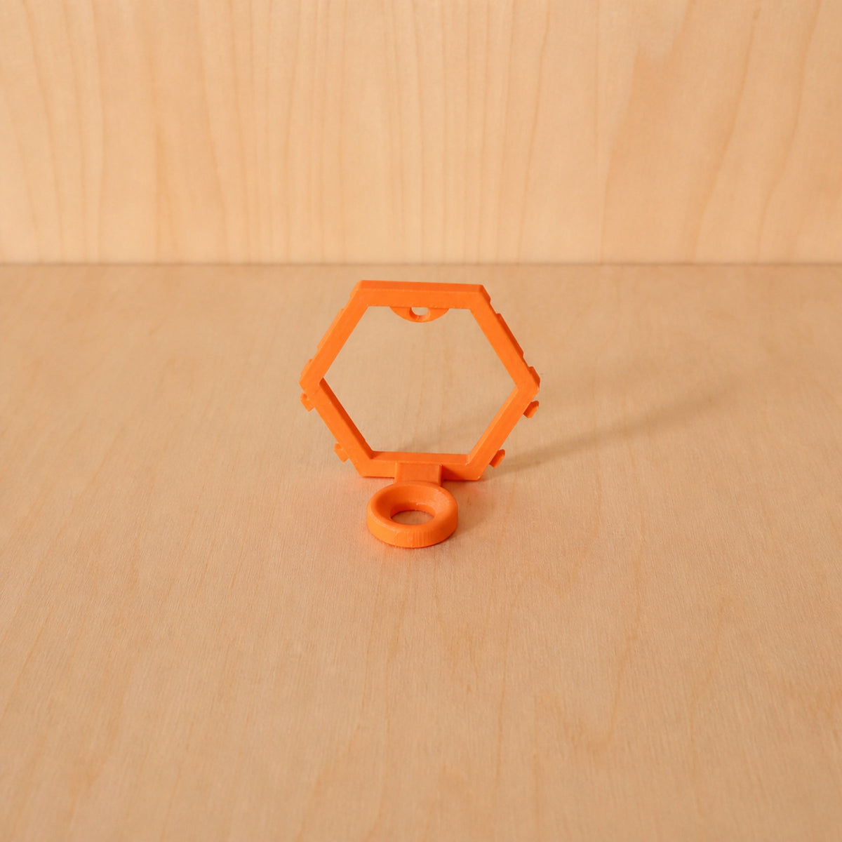 Orange modular golf ball display mount on pale wood