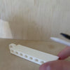 Golf Tee Holder being loaded with and emptied of eight golf tees