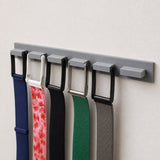 Angled close-up of the grey six-position wall holder with WHOOP bands